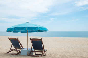 Beach chairs and blue umbrella on beautiful sand beach with cloudy and blue sky - 172115369
