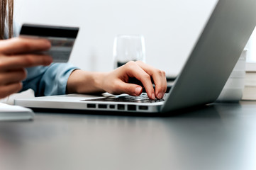 Close up of female hands making online payment.