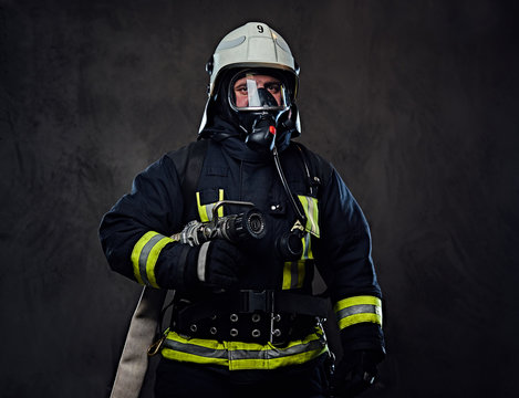 Firefighter dressed in uniform and an oxygen mask.