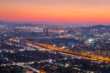 Seoul City and skyline with skyscrapers in Sunset, Han river in Aerial view of Yongma Mountain or Yongmasan