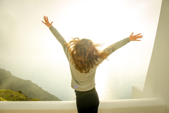 Girl with arms open, sea in background, Oa, Santorini, Kikladhes, Greece