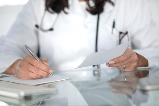 Cropped view of doctor writing prescription