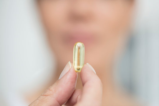 Woman holding pill