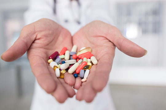 Cropped view of doctor holding pills