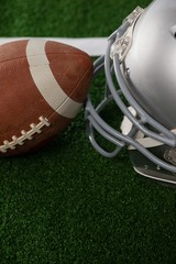 High angle view of American football by sports helmet