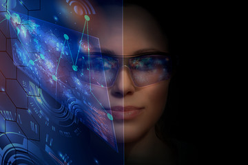 Close-up portrait of young and beautiful woman with the virtual futuristic glasses ( technology concept).Virtual holographic interface and young woman wearing glasses
