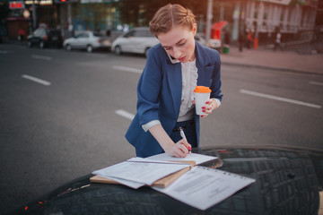 Busy woman is in a hurry, she does not have time, she is going to talk on the phone on the go....