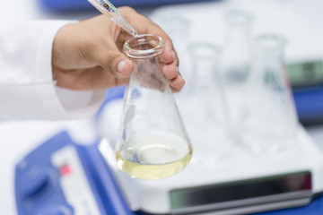 Fototapeta premium Experiment chemical solution mixing liquids on a Hotplate Stirrer in Lab.