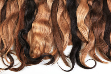 Mix of natural extensions hair: blond, red, brown. Strands of hair for hairstyles. Isolated on white background.