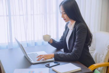 Young business woman using laptop