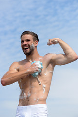 Man with bristle laughing and showing muscles