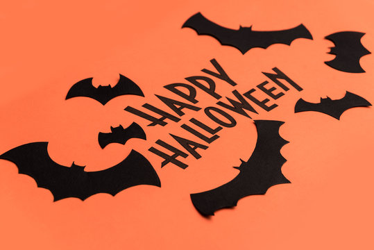 Black logo of Halloween and black bats painted on orange background