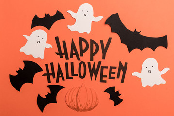 Hand written phrase Happy Halloween with traditional symbols near it