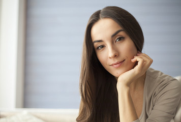 Close up portrait of attractive young woman at home.