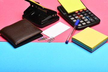 Office tools: calculator, hole punch, card, note paper, pen, clips