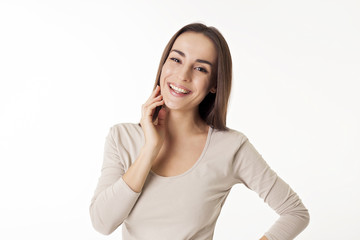 Fototapeta premium Portrait of a cheerful and beautiful girl with copy space. Isolated on white