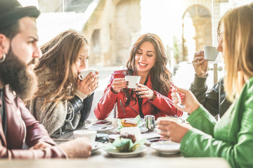 Young friends toasting coffee and doing breakfast in bar bakery shop