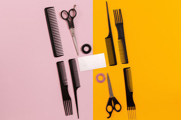 Combs and hairdresser tools on color background top view
