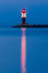 Fototapeten night view of lighthouse of Warnemuende on the Baltic Sea at the © eplisterra