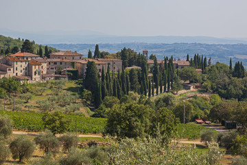 Fototapeta na wymiar Traditional village is surrounded by picturesque hills in the Chianti region, Tuscany, Italy