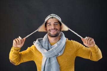 Portrait of smiling man holding wooly hat