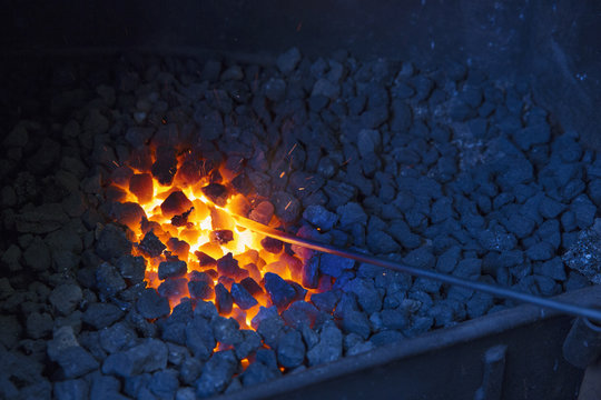 Glowing red coals in a large hot fire