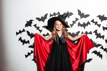 Funny little girl dressed in halloween costume posing
