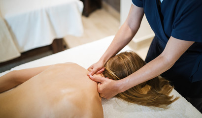 Fototapeta na wymiar Therapist massaging patient at wellness spa