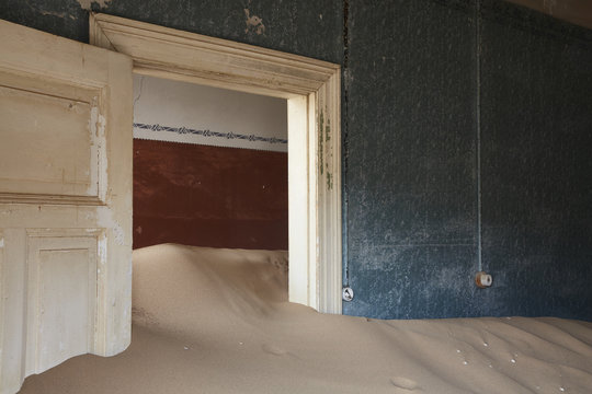 Interior of an abandoned building full of sand.