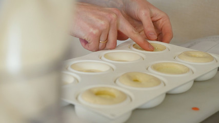 Homemade chocolate muffins in silicone mold in oven. Cooking muffins in the mold, closeup