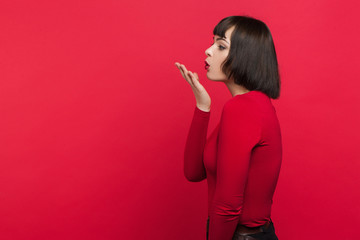 Flirty young female. Seduction background. Woman sending air-kiss, love relationship concept