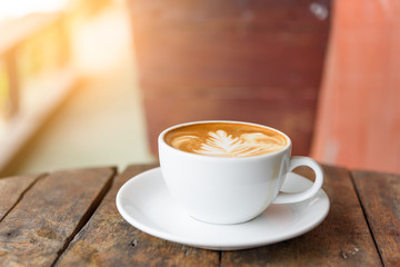 coffee cup Latte art on old vintage blue wood table outdoor with copy space for text