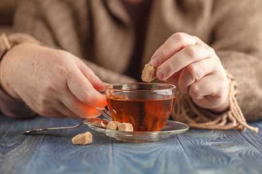 Dunking Sugar In Hot Tea