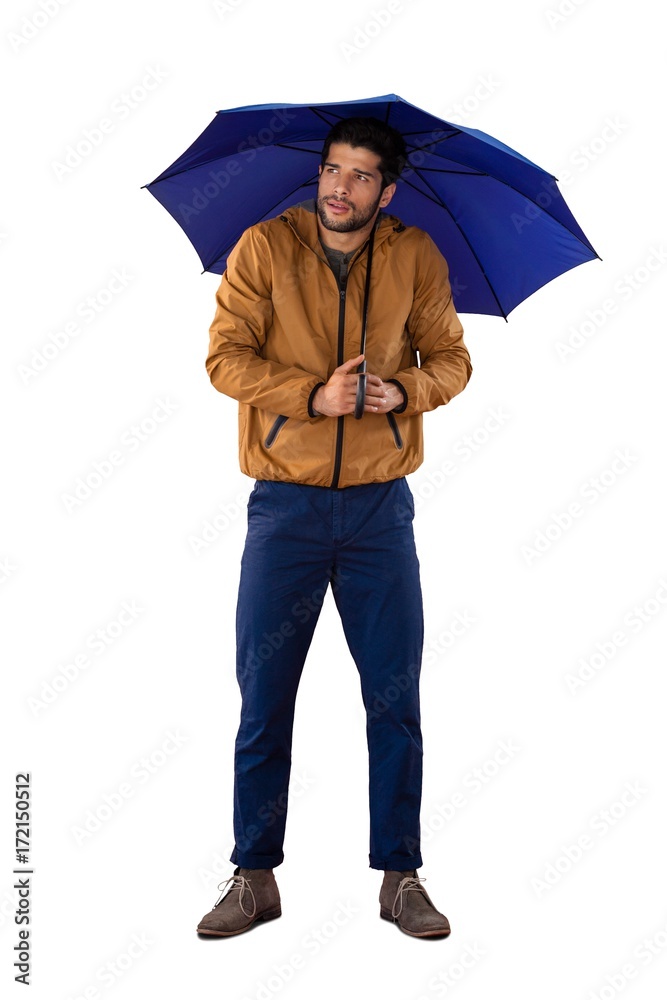 Wall mural Man standing under umbrella