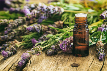 Fresh lavender and essential oil on wooden background - obrazy, fototapety, plakaty