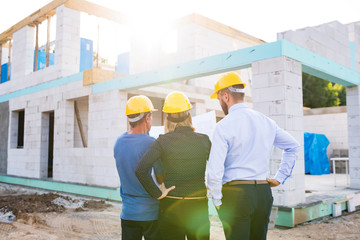 Architects and worker at the construction site.