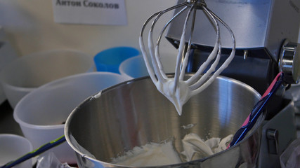 Cream in a blender for cake. Pastry blender after work