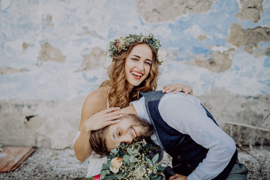 Beautiful Bride And Groom In Front Of Old Shabby House.