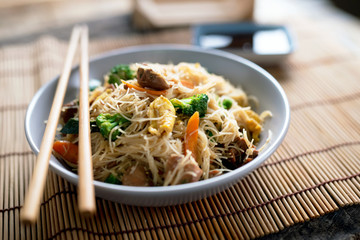 Asian rice noodles wok with chicken and vegetables