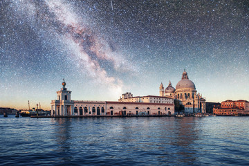 Fototapeta na wymiar Gondolas on the canal at night in Venice, San Giorgio Maggiore church. San - Marco. Fantastic starry sky and the Milky Way.