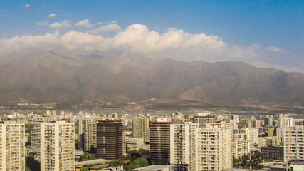 Tall buildings in Santiago's skyline with Andes mountains in the background