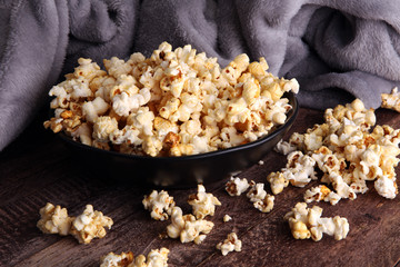 Salt popcorn or sweet popcorn in bowl on the wooden table