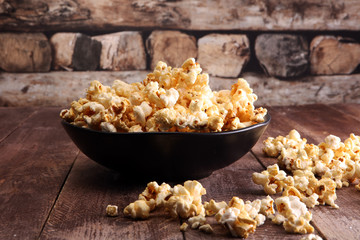 Salt popcorn or sweet popcorn in bowl on the wooden table