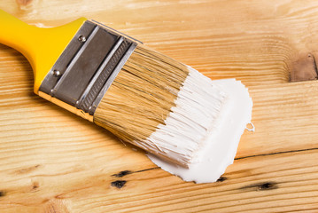 White Paint Can with Brush Top View On wooden Background.