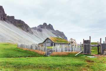 Fototapeta na wymiar Traditional Viking village. Wooden houses near the mountain first settlements in Iceland.