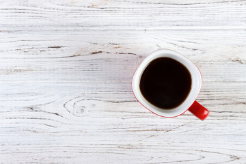 red coffee cup on wood table top view