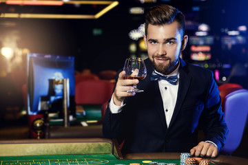 Handsome man playing roulette in the casino