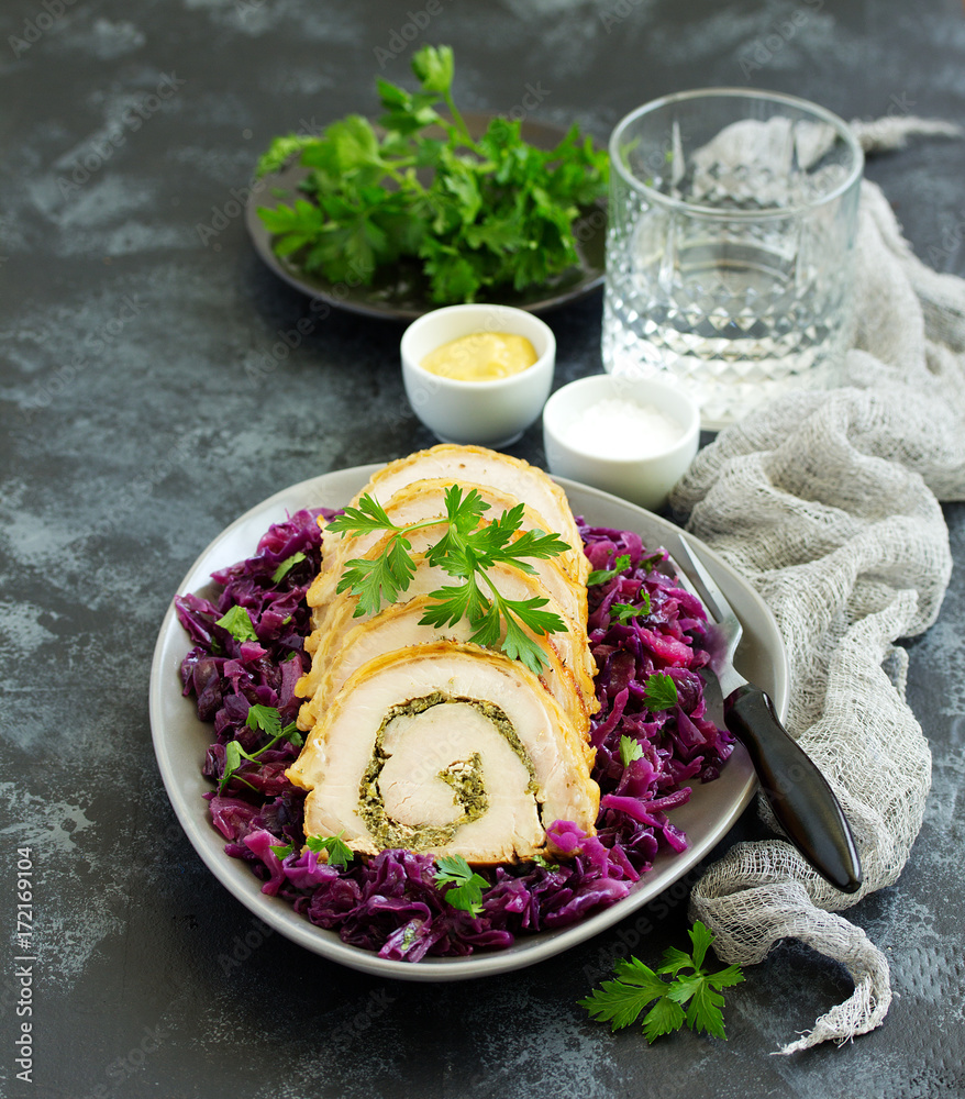 Wall mural Fried pork loin stuffed with greens and red cabbage.