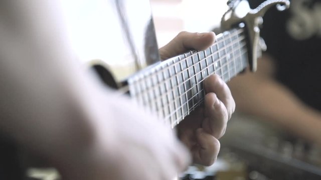 Man strumming guitar
