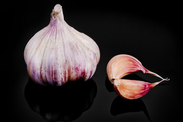 Garlic with reflection on black background.